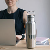 Klean Kanteen Insulated Rise Reflect 592ml brushed bottle on a desk beside a laptop - K1011496
