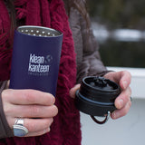 Woman holding Klean Kanteen TKWide with Cafe Cap removed in the city