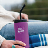 Close up of Klean Kanteen TKWide insulated bottle with straw cap in woman's lap